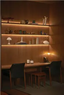  ??  ?? This page
MK27’s signature sense of warmth pervades the family room, where on one side is a custom desk with chairs by Ib Kofod-Larsen and a custom shelving unit that displays even more objets d’art