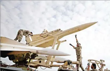  ?? AMIN KHOROSHAHI/ISNA/AFP ?? Iranian soldiers prepare to launch a Hawk surface-to-air missile during military manoeuvres at an undisclose­d location in Iran on November 13, 2012.