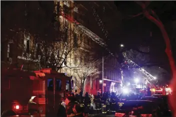  ?? PHOTO/FRANK ?? Firefighte­rs respond to a building fire Thursday in the Bronx borough of New York. The Fire Department of New York says a blaze raging in the Bronx apartment building has seriously injured more than a dozen of people. AP FRANKLIN II
