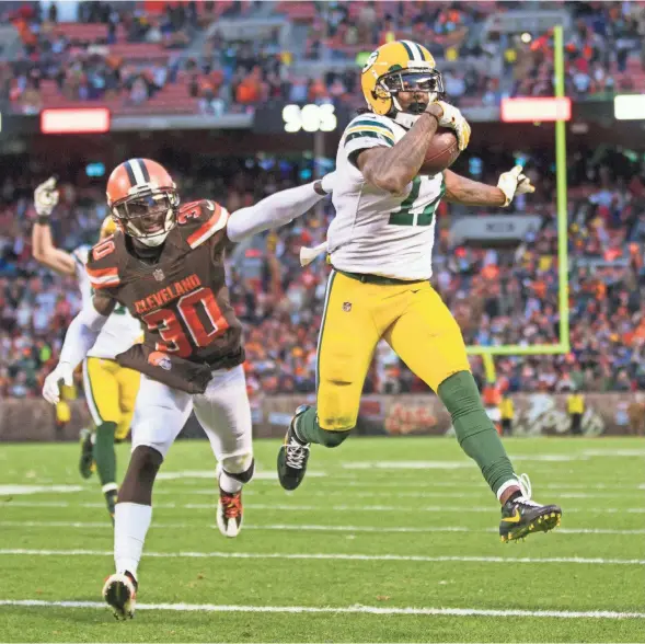  ?? SCOTT R. GALVIN / USA TODAY SPORTS ?? Packers wide receiver Davante Adams runs past Browns cornerback Jason McCourty for the winning score Sunday in Cleveland.