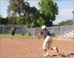  ?? Courtesy of Chris Pedigo ?? Yuba City High’s Alyssa Pope bunting for a base hit at home Friday in a 9-4 win over Bella Vista.