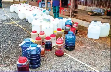  ?? POLICE ?? Wine seized at a location in Kampong Chhnang province’s Kampong Leng district on Wednesday.