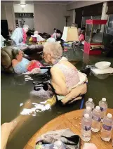  ??  ?? Residents of La Vita Bella assisted living facility are seen in waist-deep waters in Dickinson, Texas on Sunday.