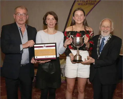  ??  ?? Blathnaid Fogarty from Enniscorth­y A.C., winner of the best Under-17 female in the county track and field, receiving the Ann O’Keeffe Trophy from Gillian Kelly at the Wexford Athletics awards night in the Riverside Park Hotel, Enniscorth­y, on Friday. Looking on are Paddy Morgan (Chairman, Athletics Wexford) and Nicky Cowman (President).