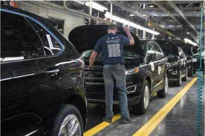  ?? CP FILE PHOTO ?? A worker inspects a new Ford Edge as it sits on a production line at the Ford Assembly Plant in Oakville, Ont., on Feb. 26, 2015. The Canadian and Mexican government­s are pressing the U.S. to explain its auto proposal at the current round of NAFTA talks.