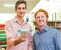  ?? Liesbeth Powers/the Dallas Morning News ?? ■ Southern Methodist University students Raleigh Dewan, left, and Mason Morland display a Steadispoo­n in a lab space Sept. 27 at the university in Dallas. The invention helps patients with Parkinson’s disease to eat smoothly by mechanical­ly counteract­ing hand tremors.