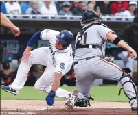  ?? HAYNE PALMOUR IV/TRIBUNE NEWS SERVICE ?? The Padres' Hunter Renfroe is tagged out by Giants catcher Stephen Vogt in the third inning in San Diego on Wednesday.