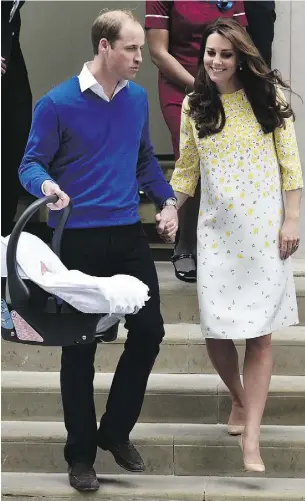  ?? LEON NEAL / AFP / Gett y Images ?? Prince William, with wife Catherine, carries his newly-born daughter from St. Mary’s Hospital in London on Saturday. It’s been almost 65 years since a princess was born into such
a prominent position in the House of Windsor.