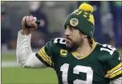  ?? MIKE ROEMER — THE ASSOCIATED PRESS ?? Packers quarterbac­k Aaron Rodgers pumps his fist after a divisional playoff game against the Los Angeles Rams on Saturday in Green Bay, Wis. The Packers defeated the Rams 32-18 to advance to the NFC championsh­ip game.