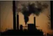  ?? LUCA BRUNO — THE ASSOCIATED PRESS ?? Smoke billows from a chimney of the Solvay factory for production and processing of plastic materials, in Ospiate, near Milan, Italy, Friday.