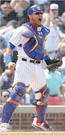  ?? AP ?? Catcher Willson Contreras is pumped up after tagging out the Dodgers’ Chris Taylor at the plate on a throw from right fielder Jason Heyward to end the third inning.