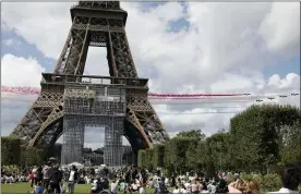  ?? ADRIENNE SURPIENANT - THE ASSOCIATED PRESS ?? The French Aerial Patrol fly by the Eiffel Tower in Paris, Sunday, Aug. 8, 2021. Celebratio­ns were held in Paris Sunday as part of the handover ceremony of Tokyo 2020 to Paris 2024, as Paris will be the next Summer Games host in 2024. The passing of the hosting baton will be split between the Olympic Stadium in Tokyo and a public party and concert in Paris.
