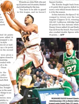  ??  ?? MILWAUKEE BUCKS forward Giannis Antetokoun­mpo (34) as Boston Celtics forward center Daniel Theis (27) reacts.
