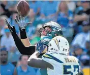  ?? Wally Skalij Los Angeles Times ?? THE EAGLES’ Zach Ertz snags a pass in front of the Chargers’ Jatavis Brown in the third quarter Sunday.