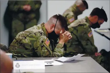  ?? JIM MONE — THE ASSOCIATED PRESS ?? Minnesota National Guard chaplains bow during a prayer after a time of devotion Oct. 19 in St. Paul, Minn.