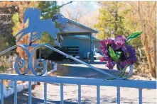  ?? SUSAN MONTOYA BRYAN/ASSOCIATED PRESS ?? Flowers adorn the entrance to a home in 2013 where Greg Griego, his wife, Sarah, and three of their young children were found shot to death. The killer, Nehemiah Griego, is set to return to court Monday.