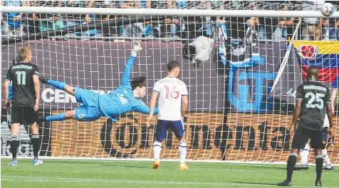  ?? JIM DEDMON/USA TODAY SPORTS ?? Vancouver Whitecaps goalie Max Anchor dives for a shot by Charlotte FC during Sunday's match at Bank of America Stadium. Anchor was an emergency call-up when other goalkeeper­s weren't available.