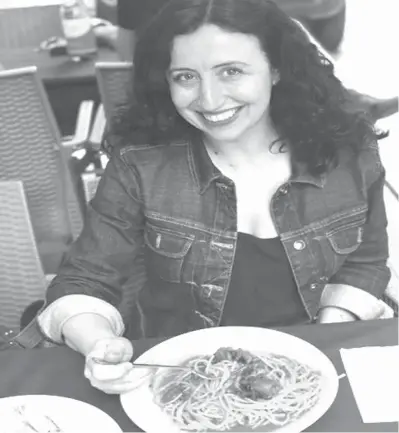  ?? Christian Galliani via AP ?? ABOVE: Danielle Oteri poses with a plate of pasta on May 11 in Naples, Italy. Oteri runs a company called Feast on History that gives tours in Italy and New York City and has been offering tours
of Italian food shops in the Bronx since 2007.
Both...