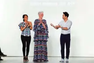  ??  ?? Model Maye Musk (center) is honored by designers Younhee Park (left) and Lee Chung after walking the runway for the Concept Korea show during New York Fashion Week.