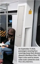  ?? PAUL BIGLAND/ RAIL. ?? On September 9 2020, passengers wearing face coverings keep their distance aboard a Northern Class 195. Tape is also used to ensure some seats cannot be used.