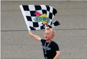  ?? ASSOCIATED PRESS ?? Kevin Harvick’s son, Keelan, runs with the winners flag after a NASCAR Cup Series auto race at Michigan Internatio­nal Speedway on Sunday.