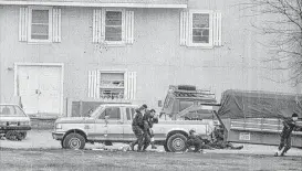  ?? Associated Press file ?? Bureau of Alcohol, Tobacco and Firearms agents help evacuate a wounded agent near the end of the Feb. 28, 1993, raid on the Branch Davidian compound.