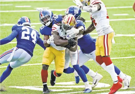  ?? COREYSIPKI­N/AP ?? San Francisco 49ers’JaMycal Hasty, center, runs the ball during the second half of an NFL football game against the NewYork Giants on Sunday in East Rutherford, N.J.