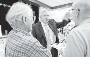  ?? Craig Moseley / Staff photograph­er ?? Precinct 3 Commission­er Steve Radack talks to residents at a meeting on flood control last August. Commission­ers hold enormous control over who is awarded county contracts, including flood control projects.