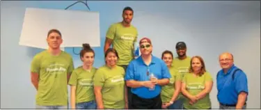  ?? NICHOLAS BUONANNO -- NBUONANNO@TROYRECORD.COM ?? Employees of the Bonadio Group wear their green Purpose Day shirts while volunteeri­ng at the Rensselaer NYSARC on Thursday.