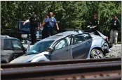  ?? JOSE CARLOS FAJARDO — STAFF PHOTOGRAPH­ER ?? Contra Costa sheriff's deputies examine the scene of a crash between an Amtrak train and a car on Sunday.