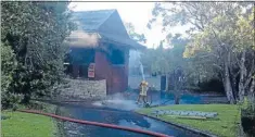  ?? Photo: JULIAN RAETHEL ?? Firefighte­rs dampen down the Four Kauri Family Medical Centre on New North Rd after fire ripped through it.