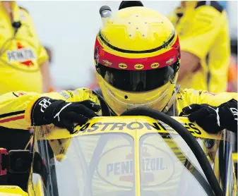  ?? DARRON CUMMINGS, THE ASSOCIATED PRESS ?? Helio Castroneve­s, of Brazil, climbs into his car during a practice session for the Indianapol­is 500 auto race at Indianapol­is Motor Speedway on Wednesday.