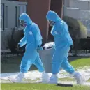  ?? TIM KROCHAK • THE CHRONICLE HERALD ?? Workers in full personal protective equipment are seen removing a waste bin from a residence at the Northwood long-term care facility in Halifax.