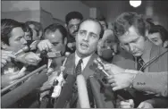  ?? AP PHOTO, FILE ?? In this Jan. 26, 1971, file photo, Manson trial chief prosecutor Vincent Bugliosi talks with reporters outside a Los Angeles courtroom. Bugliosi was an ambitious but anonymous deputy district attorney when he was handed the Manson Family murder trial after a more experience­d prosecutor was removed for mocking one of the defendants to reporters. He denounced Manson as the “dictatoria­l maharajah of a tribe of bootlickin­g slaves,” calling Manson’s followers “robots” and “zombies.” After their conviction­s, he recounted the case in “Helter Skelter,” one of history’s best-selling true-crime books. He died of cancer at age 80 in 2015.