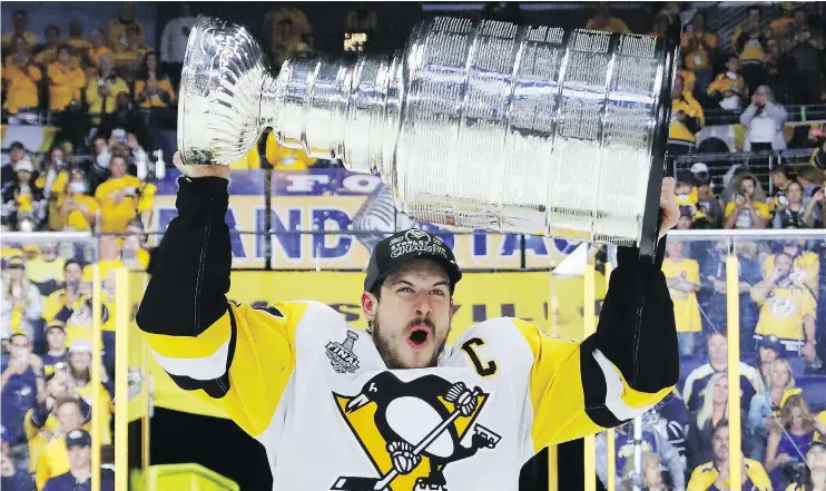  ?? — GETTY IMAGES ?? Penguins captain Sidney Crosby lets out a howl as he hoists the Stanley Cup after Sunday’s 2-0 win over the Predators in Game 6.