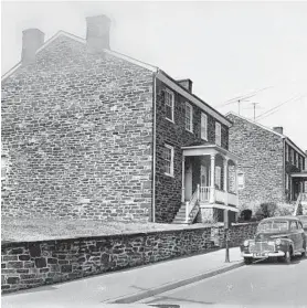  ??  ?? The distinctiv­e dark stone used to build workers’ cottages was quarried from the Jones Falls. The cottage style of housing helped to distinguis­h the Baltimore-area mill town from those in England, according to Nathan Dennies.