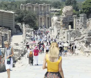  ??  ?? Tourists visit the ancient city of Ephesus near İzmir in the western Aegean region, Turkey, Aug. 5, 2018.