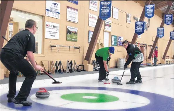  ?? SARA ERICSSON ?? A team of U14 curlers sweep as the rock makes its way down the ice at the eighth annual Earl MacKinnon Classic Jan. 21 at the Glooscap Curling Club in Kentville.