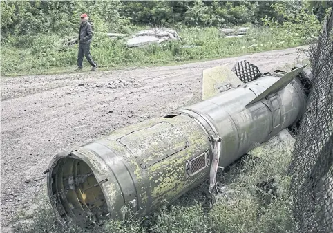  ?? AFP ?? A man walks near the remains of a missile in the city of Lysychansk, in the eastern Ukrainian region of Donbas, on Thursday.