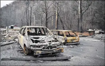  ?? ANDREW NELLES/THE TENNESSEAN ?? Burned vehicles remain among the damage from wildfires Nov. 30 at Creek Place Efficienci­es in Gatlinburg, Tennessee. Dry conditions since March in much of the South have been blamed for many of wildfires, the worst of which hit the Great Smoky...