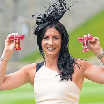  ?? ?? QUEEN OF THE CASTLE: Eve with her OBE and MBE gongs at Windsor.