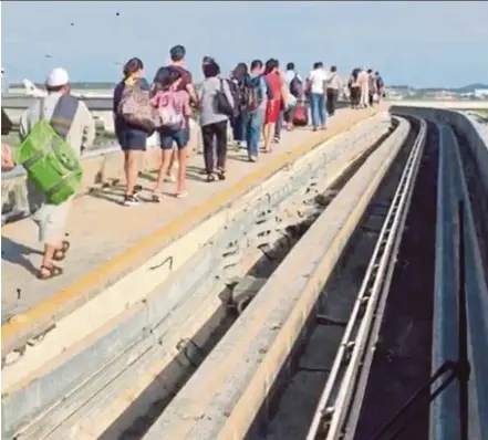  ??  ?? A video clip made available to the ‘New Straits Times’ showing passengers walking along the tracks when an aerotrain broke down at the Kuala Lumpur Internatio­nal Airport yesterday.