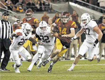  ?? Photos by Michael Macor / The Chronicle ?? USC quarterbac­k San Darnold is chased by Bobby Okereke (20), Joey Alfieri (32) and Dylan Jackson at Levi’s Stadium.