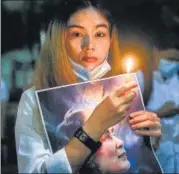  ?? REUTERS ?? A woman in Bangkok holds a picture of detained Myanmar leader Aung San Suu Kyi at a protest against the coup.