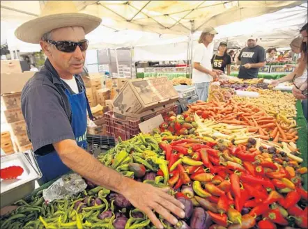  ?? Al Seib
Los Angeles Times ?? ALEX WEISER of Weiser Family Farms at his stand in the Santa Monica Farmers Market. His family is in the initial stages of working with Fresh Nation, a start-up that is delivering farmers market products through Amazon in L.A., Orange and San Diego...