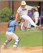  ?? Jeremy Stewart / RN-T ?? Darlington’s Kane Popham (right) is tagged out in midair by Lovett catcher Drayton Foster as he attempts to reach home during the first game of a doublehead­er in the first round of the Class AA state playoffs Friday at Darlington.