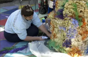  ?? Janet McConnaugh­ey/Associated Press ?? Carley Sercovich hot-glues an addition to a coral reef made of boxes and spray foam at the foot of her front steps on Jan. 15 in the Algiers Point neighborho­od of New Orleans.