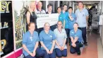  ??  ?? Cheque this From back left, Elaine Dick, Andrew Power, Christine Somerville, Heather Lee, Emily Box, Eunsuk Blackwood, Kevin Johnstone with front left, Heather Nimmo, Gillian Ayre- Toni Cairns and Joanne McEvoy