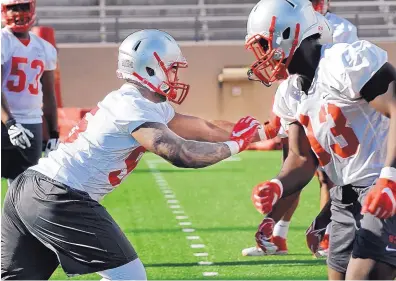  ?? JIM THOMPSON/JOURNAL ?? New Mexico senior defensive lineman Garrett Hughes, left, is a first team preseason All-Mountain West Conference selection. He led the Lobos last year with 6½ sacks and says 12 “would be amazing” this year.