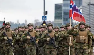  ?? ?? Norwegian soldiers march during a military parade ceremony.